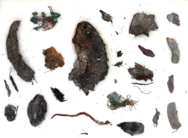 38. Fabric Remnants from Spiro Mound. Multiple: 38. Rare offering: 900 yr old Fabric Remnants from Spiro Mound. 8” x 10” sealed Riker Frame with multiple fabric examples