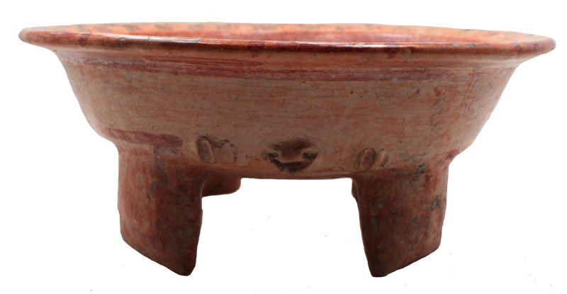 10 1/2" D. Four legged bowl with flat feet. 5 buff: 10 1/2" D. Four legged bowl with flat feet. 5 buff panels with geometric design, small face modeled on one side with rattle legs. Interior has a checkered black and orange rim. Nayarit, MX. 100 BC to 
