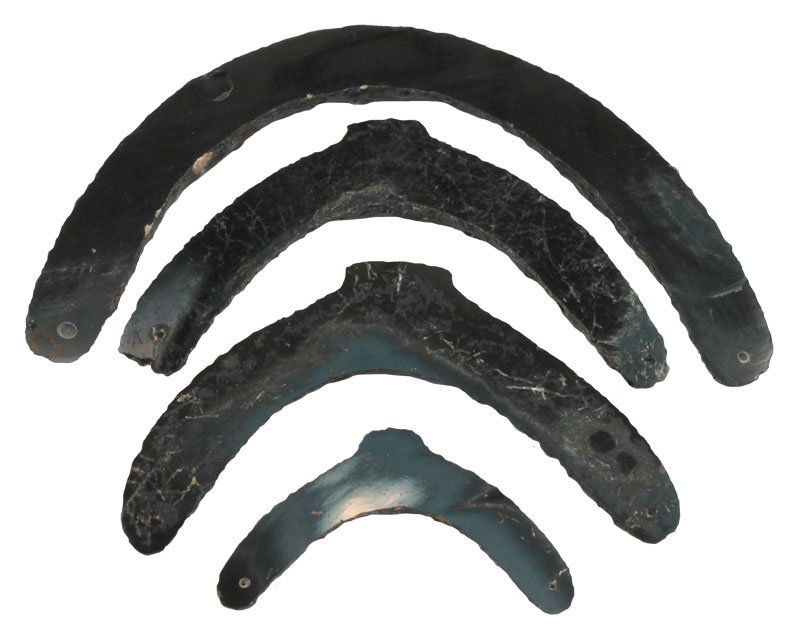 Four. Obsidian Gorgets. Drilled, cut from glossy black: Four. Obsidian Gorgets. Drilled, cut from glossy black Obsidian. 2 3/4" to 5 3/4". PreColumbian. From the Riddick Collection.