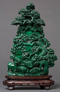 A CARVED MALACHITE LIDDED JAR WITH BONZAI TREE: Fine carved malachite jar with intricate bonzai tree, cranes and deer. Mounted on a carved and chased wood base. Measures 13 x 8 inches overall.