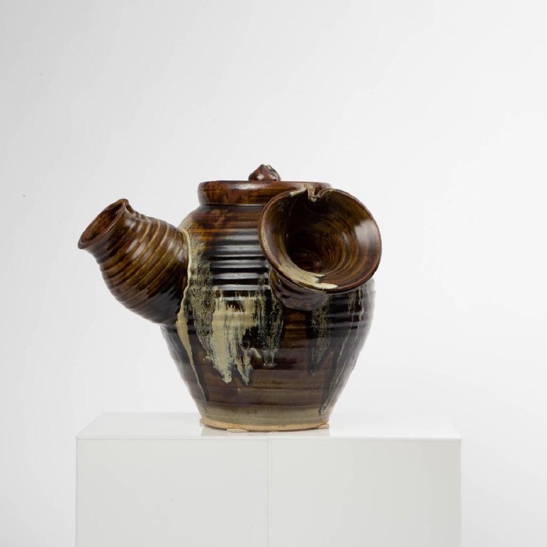 A JAPANESE YOKODE NO KYUSU ART POTTERY TEAPOT: A fine yokode no kyusu (side hand tea pot) in a monumental size, with horizontal ribs, and includes the original lid. Unsigned, very nice dark green, brown and cream colors. Measures 14.25 x 16 inches