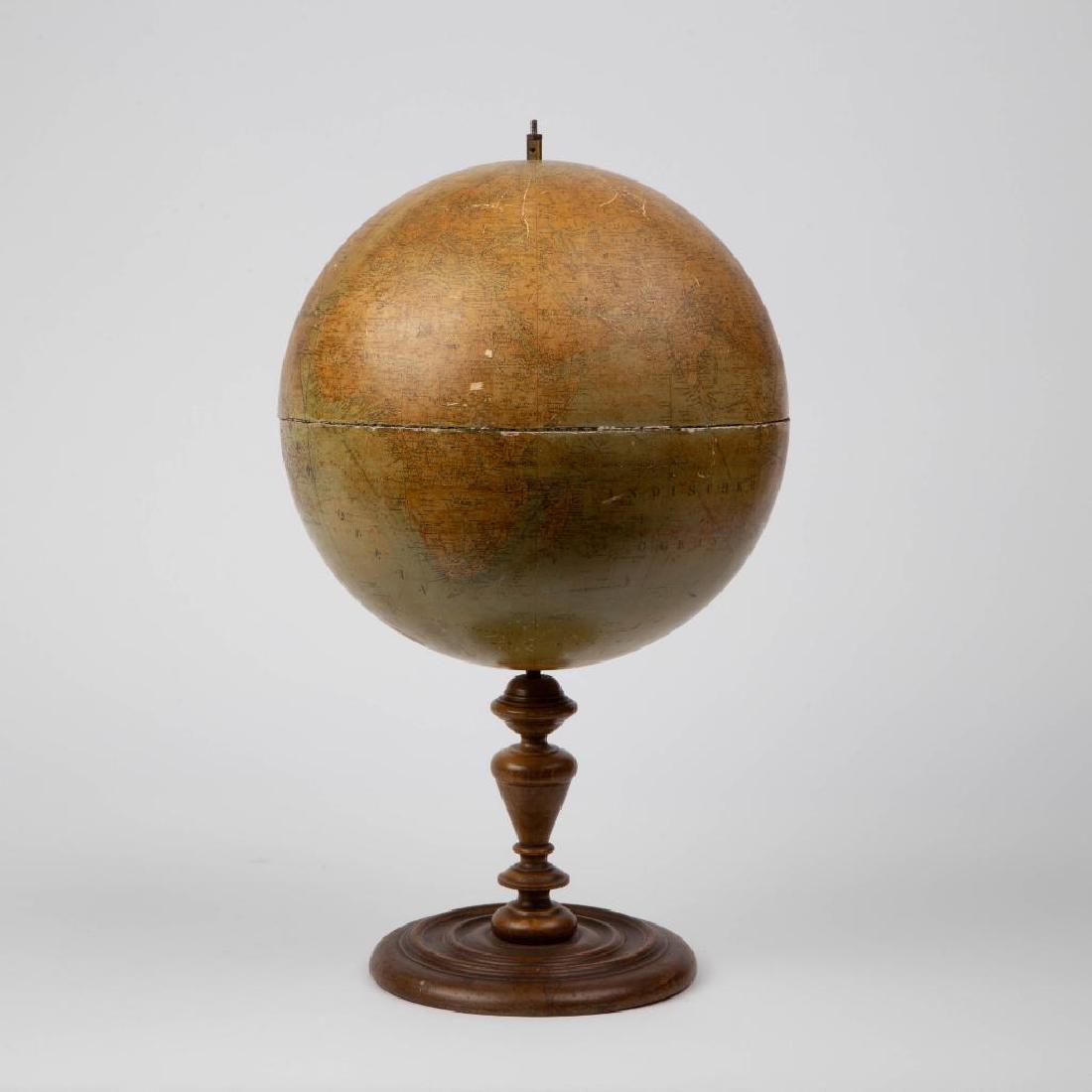 A L.J. HEYMANN WORLD GLOBE CIRCA 1900: A turn-of-the-century globe by Ludwig Jul. Heymann, and mapped by Dr. Henry Lang of Berlin, paper overlaid two hemispheres joined at the equator. Charts telegraph and some shipping lines. Measures app