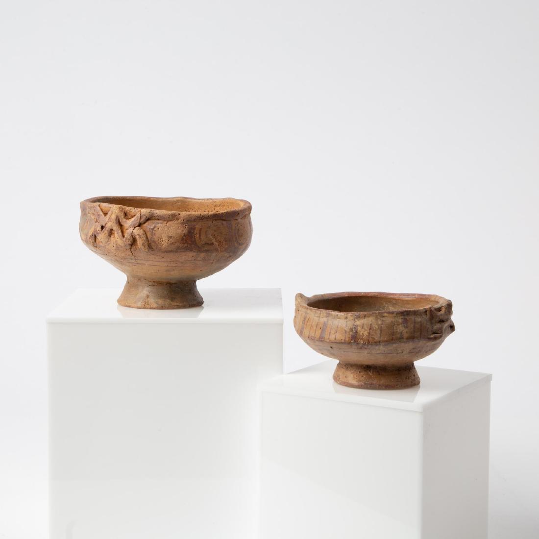 TWO PRE-COLUMBIAN MUISCA BICHROME FROG BOWLS: Pre-Columbian Muisca (Muysca) culture (Colombia, 1200-1500 CE). Pottery pedestal bowl with red/brown pigment on tan ground, banded interior. Two stylized frogs applied to opposite sides near the rim,