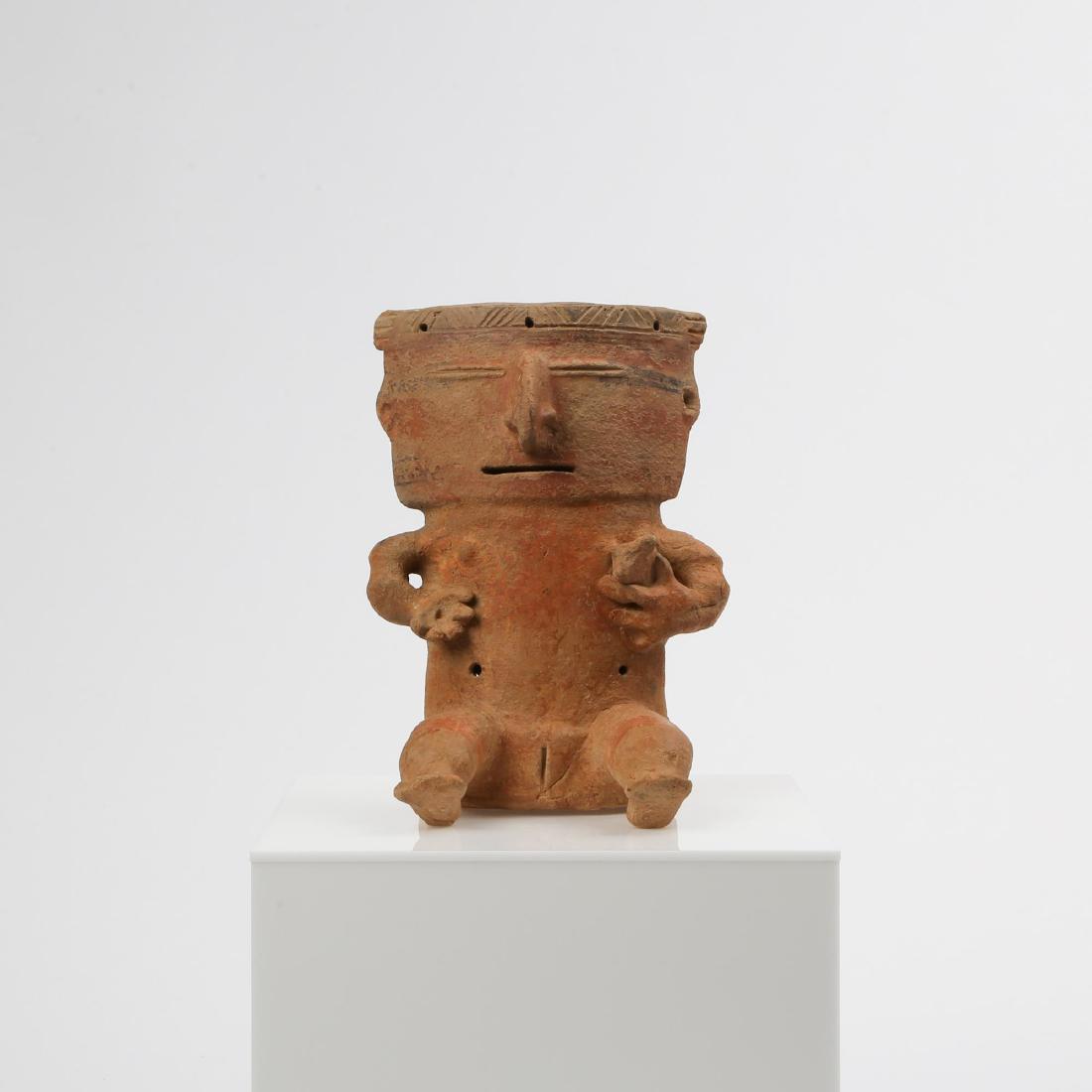 A PRE-COLUMBIAN QUIMBAYA FEMALE RETABLO FIGURE: Pre-Columbian Quimbaya culture (Colombia, 100 BC - 700 CE). Seated slab pottery polychrome figure with slit eyes and mouth. Female figure with small breasts and genitals, nursing a stylized child held