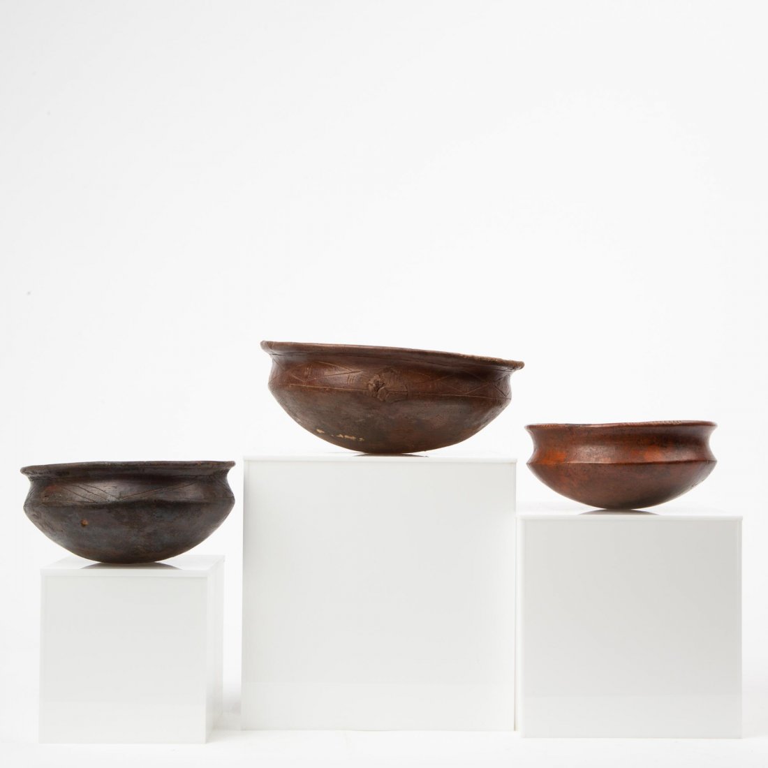 THREE QUIMBAYA CULTURE LARGE BOWLS, PRE-COLUMBIAN: Pre-Columbian Quimbaya culture (Colombia, 100 BCE-700 CE). Three sizeable round-bottomed bowls with wide flared rims, hand incised patterns on the shoulders of one small bowls and the large example, w