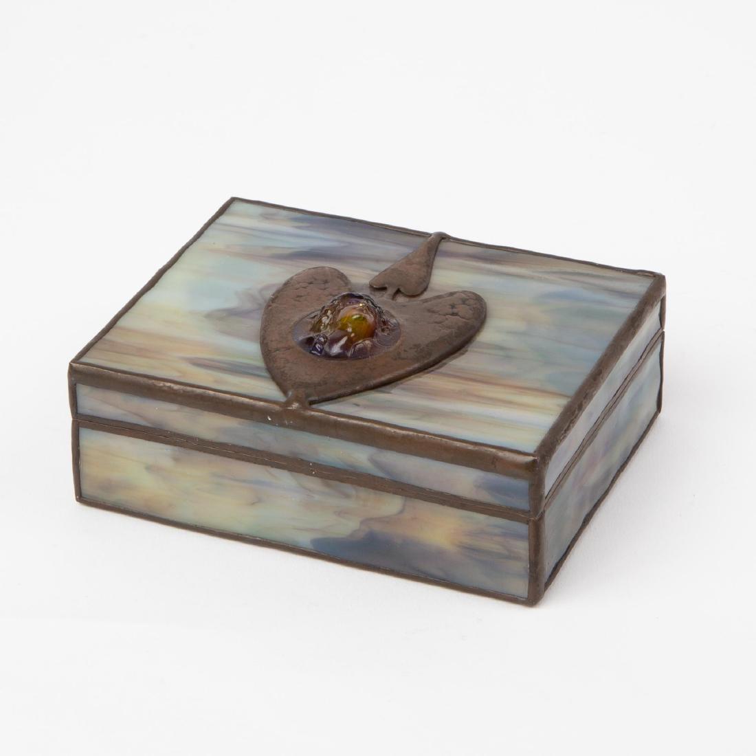 ORIENT & FLUME CAMEO ART GLASS BOX: An Orient & Flume art glass box with molded glass cameo design set upon a metal Art Nouveau inspired design. Marked on the inside lip of the lid "Orient & Flume B1976SÂ 41", indicating the artist is