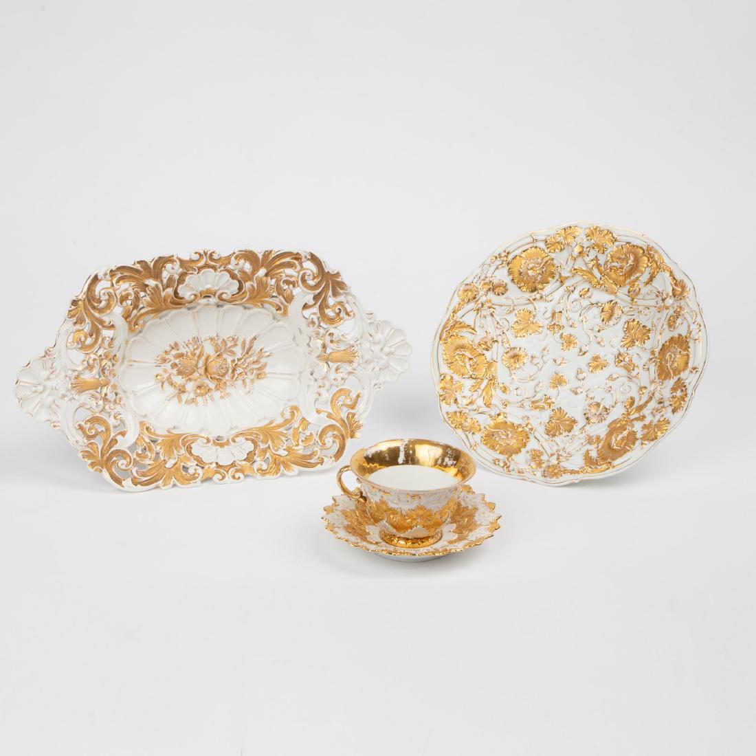 FOUR ANTIQUE MEISSEN GILT PORCELAIN DISHES: Four antique gilt porcelain dishes, each with the blue Meissen crossed swords mark on the base, including a reticulated centerpiece bowl (2.5 x 14.5 x 8.5 inches), a floral plate (1.75 x 10.5 inches),