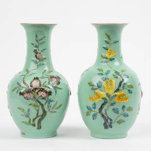 Pair of 20th c. Chinese Hand-Painted Bottle Vases: A matching pair of 20th c. hand-painted Chinese bottle vases with raised floral designs on a green ground. Each impressed with a Qinglong mark on underside and stamped "CHINA" in red ink alo