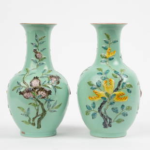 Pair of 20th c. Chinese Hand-Painted Bottle Vases: A matching pair of 20th c. hand-painted Chinese bottle vases with raised floral designs on a green ground. Each impressed with a Qinglong mark on underside and stamped "CHINA" in red ink alo