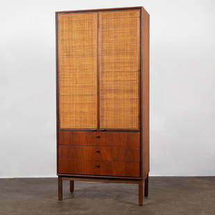 Florence Knoll (Attr.) Walnut Cabinet with Cane Doors: A 1950s tall walnut cabinet with two woven cane paneled doors above three drawers, attributed to Florence Knoll. Unmarked. 66 x 30.5 x 16 inches.