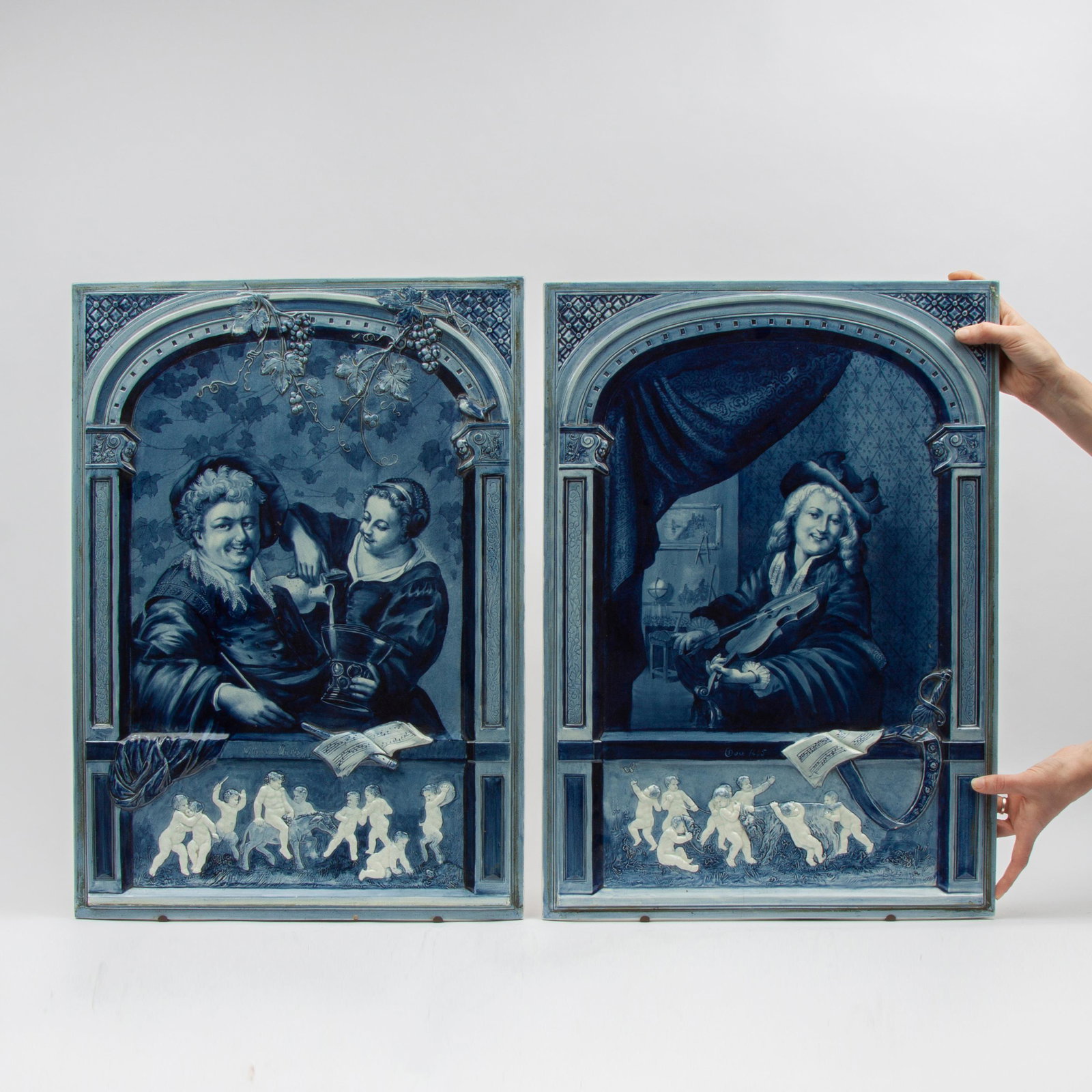 Pair of Large Villeroy & Boch J.B. Stahl Delft Plaques: A matching pair of large Villeroy & Boch (Mettlach) Delft-style stove tiles of exceptional quality, by artist Jean-Baptiste Stahl (German, 1869-1932). Circa 1895-1900. Each measure