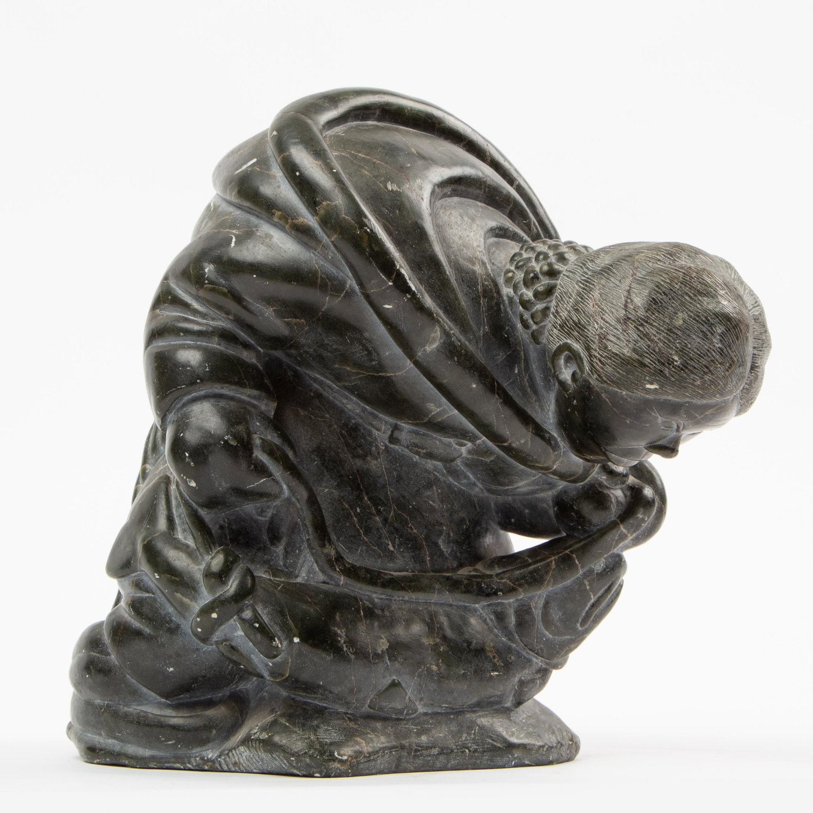 Simeonie Ohaituk Canadian Inuit Stone Carving: Simeonie Ohaituk (Canadian, b. 1941) Untitled (Hunter with Char), 1970s Carved steatite An elegant steatite carving of a hunter crouching as she holds a tied char, by Inukjuak artist Si