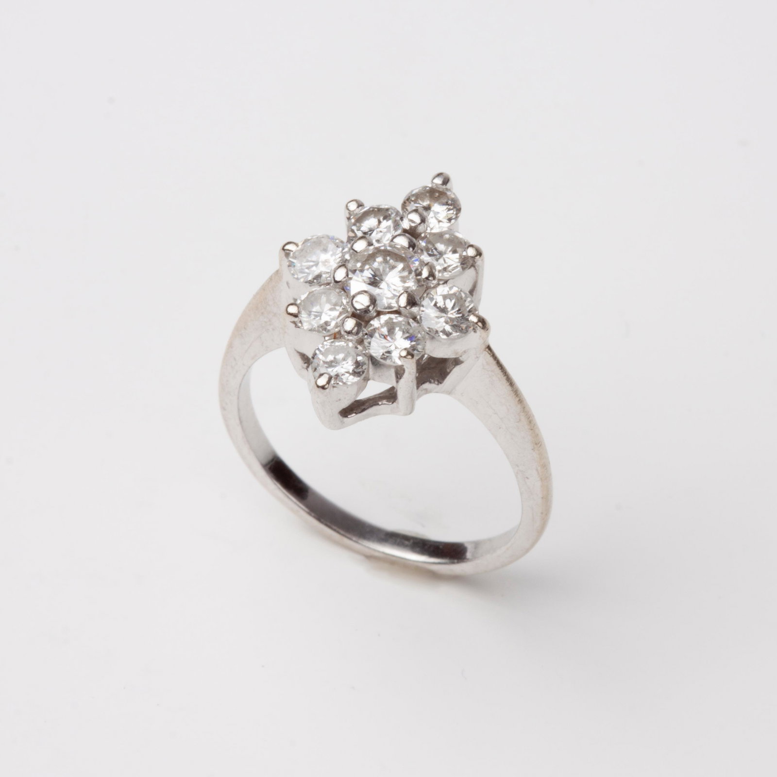 14k Diamond Cocktail Ring, .56ctw, White Gold: 14k white gold cocktail ring with nine diamonds in a diamond shape. The center diamond is a round full cut diamond set in six prongs with .24 carats, G color, I2 clarity. It is surrounded with eight p