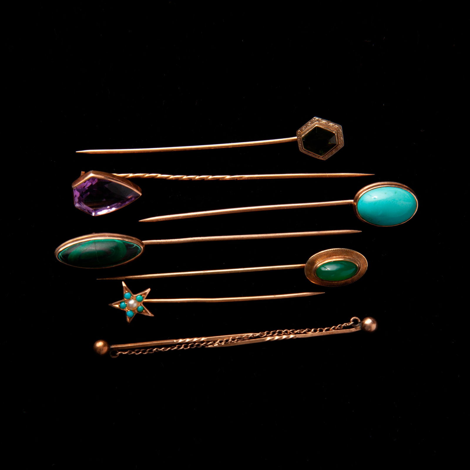 Group of 7 Gold and Gemstone Stick Pins, 14K & 18K: Group of seven vintage gold stick pins in 14k and 18k yellow gold. Includes Malachite, Amethyst, Chrysoprase, seed pearls and seed turquoise cabochons, glass, two pins connected with a small chain wit