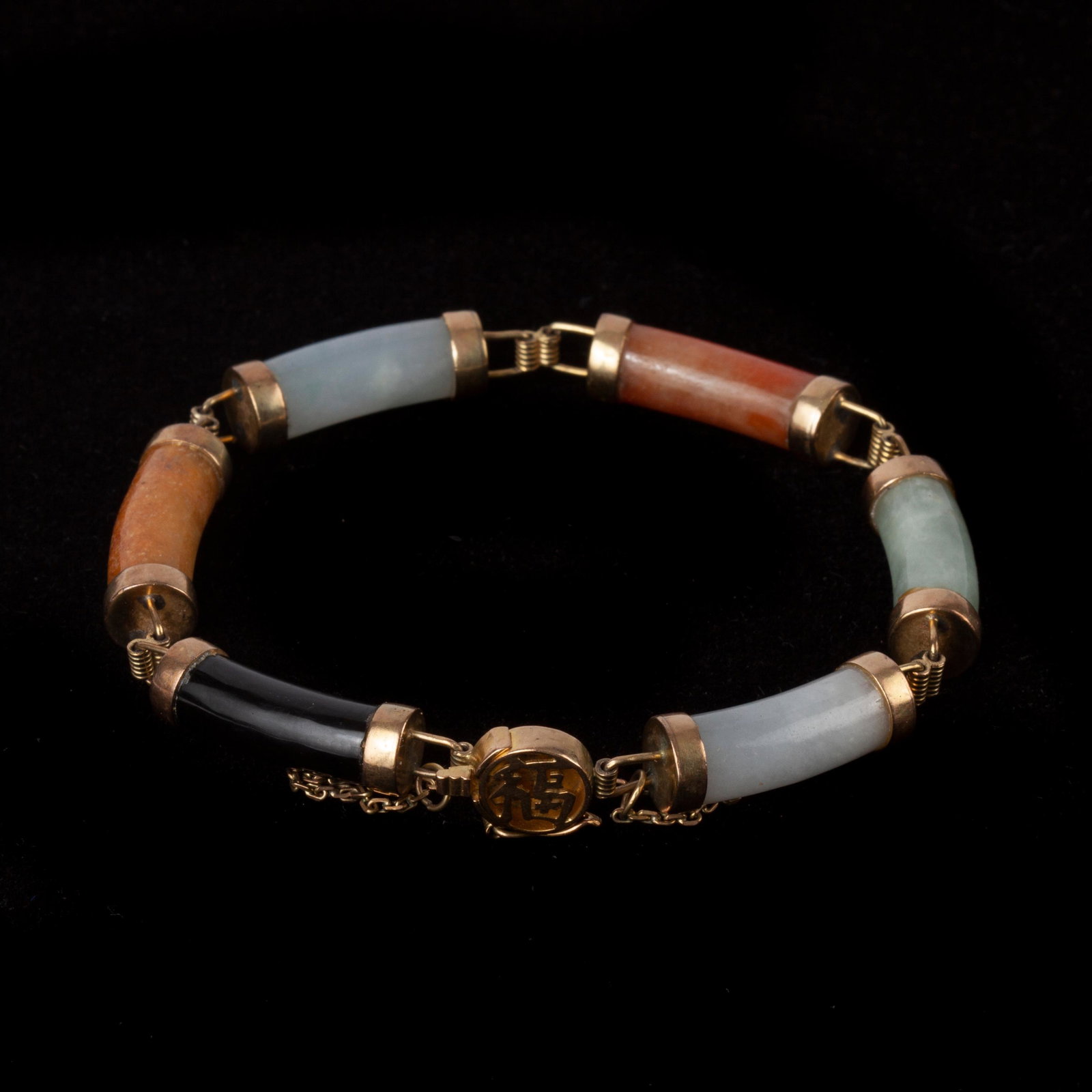 Jadeite Jade Multicolor Link Bracelet, 14k: Jadeite Jade multicolor link bracelet with 14k yellow gold hinges and round box clasp with a Chinese symbol. The clasp is marked "14K 585". It has a safety latch and a non-detachable safety chain.&nbs