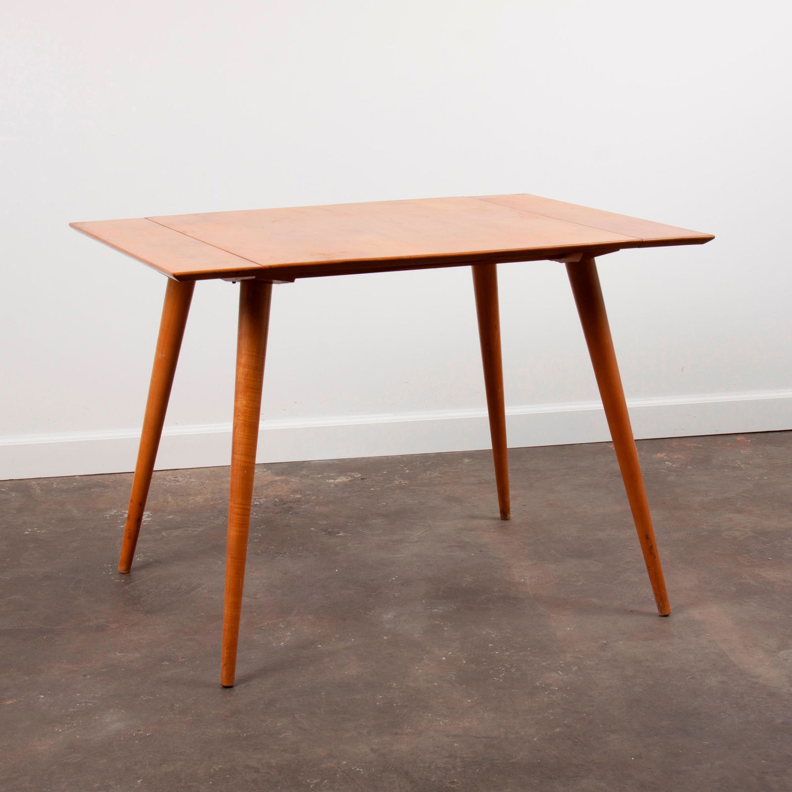 Paul McCobb Planner Group: Extension Dining Table #1521: A small extension dining table from Paul McCobb's Planner Group series, designed in 1950 for Winchendon. Original "Natural" maple finish and condition. Does not include extension inserts. Origina