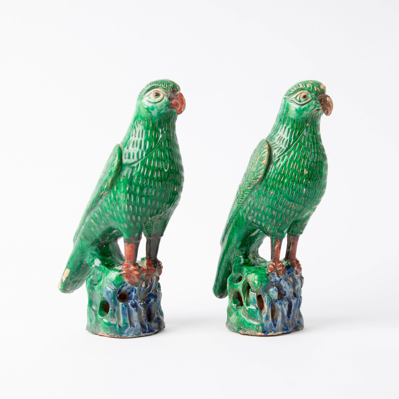 Chinese Sancai Glazed Earthenware Birds, Pair: A pair of Chinese terra cotta birds, likely late Qing, Sancai glazes. One has a hole in its back, possibly meant to hold joss sticks. Each measures approximately 10 1/2" high.