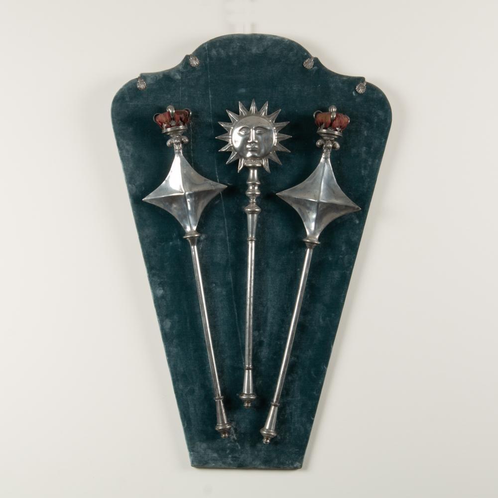 Three Odd Fellows Ceremonial Scepters Mounted on Velvet: A set of three 19th century Odd Fellows ceremonial pewter scepters, including a sun and two crowns. The velvet ground measures 42" x 28", and the scepters measure 31" to 34" in length. Provenance: The