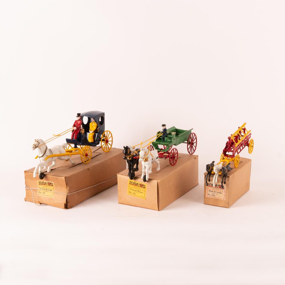 Three Kenton (No.s 162, 170, 324) Cast Iron Wagon Toys: Kenton Hardware Company (Ohio). Three cast iron toys, circa 1950. Horse-drawn hansom cab (no. 162) with removable driver and rider. Measures 4" x 13 1/2" x 6 3/4". With original box measuring 4" x 8" 