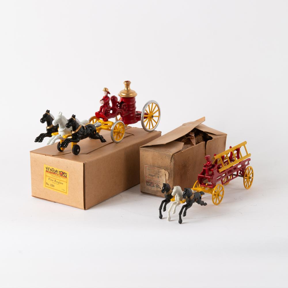 Two Kenton Cast (No.s 330 & 324) Iron Wagon Toys: Kenton Hardware Company (Ohio). Two cast iron toys, circa 1950. Three-horse fire engine (no. 330). Measures 4 3/4" x 13" x 3 3/4". With original box measuring 4" x 11 3/4" x 6". Three-horse hook & lad
