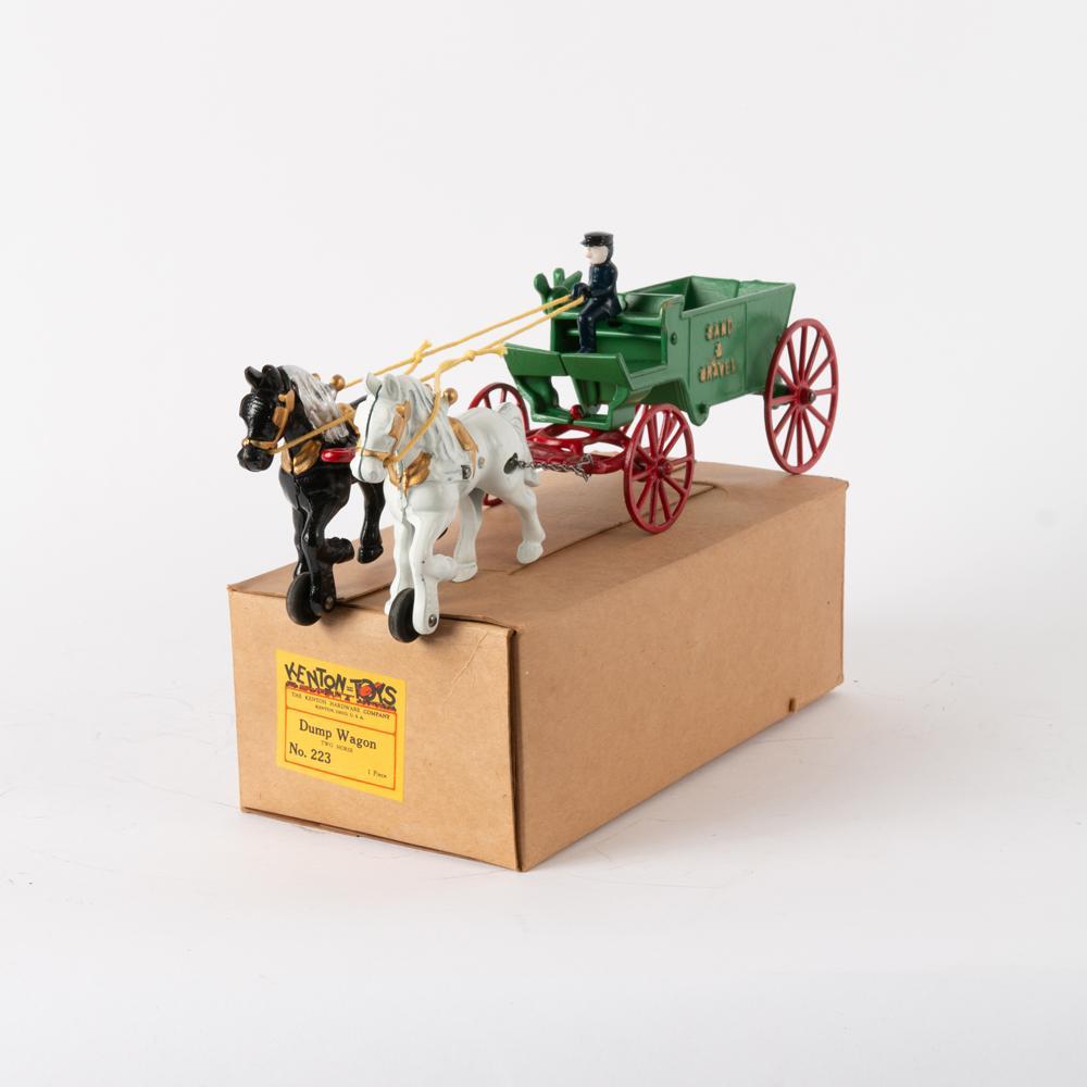Kenton (No. 223) Cast Iron Dump Wagon: Kenton Hardware Company (Ohio). Cast iron two-horse "sand & gravel" dump wagon with removable driver. Circa 1950. Measures 5" x 15 1/4" x 3 1/2". With original box measuring 4" x 11 3/4" x 6".