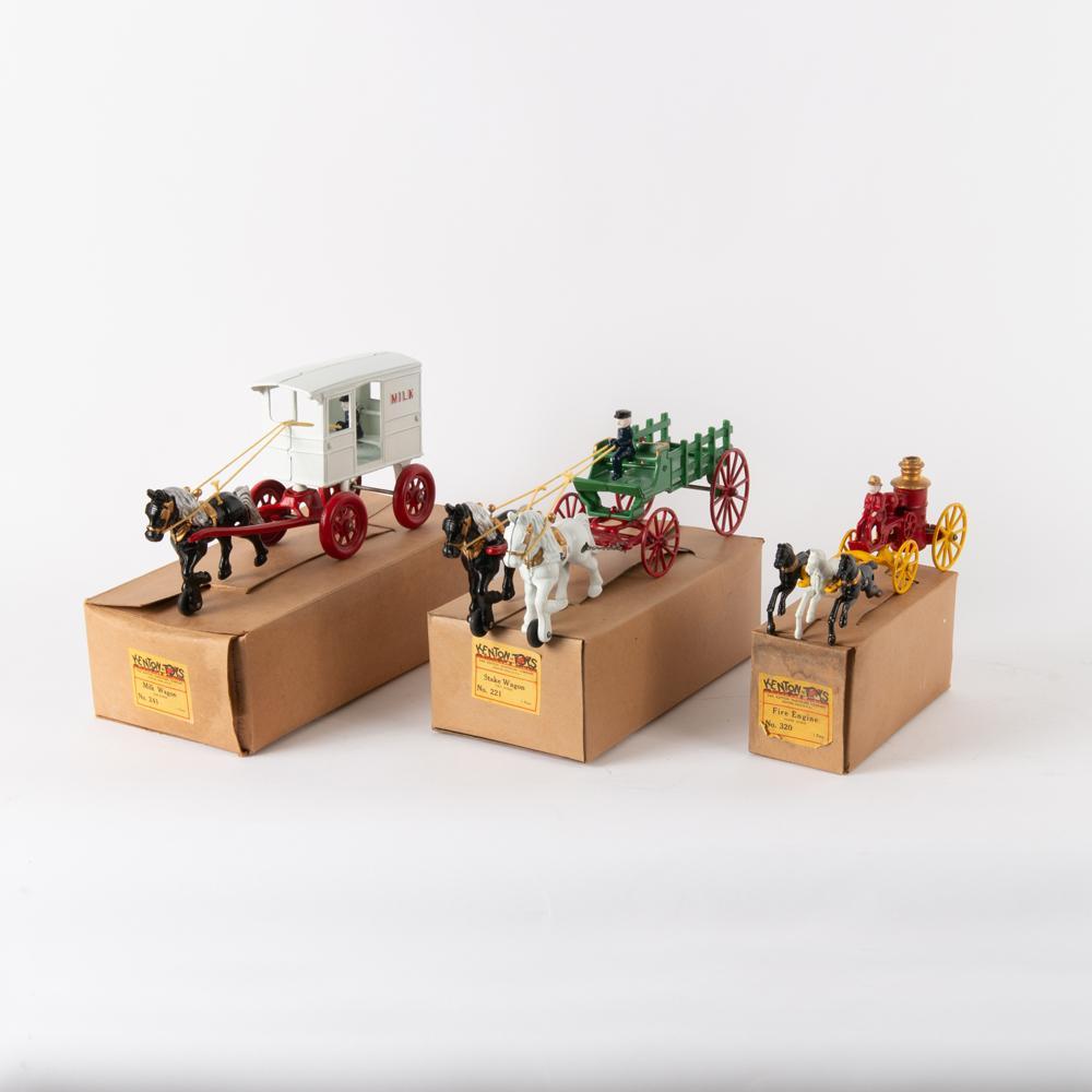 Three Kenton (No.s 241, 221, 320) Cast Iron Wagon Toys: Kenton Hardware Company (Ohio). Three cast iron toys, circa 1950. Horse-drawn milk wagon (no. 241) with removable driver. Measures 6" x 12 3/4" x 3 3/4". With original box measuring 4" x 13 1/2" 