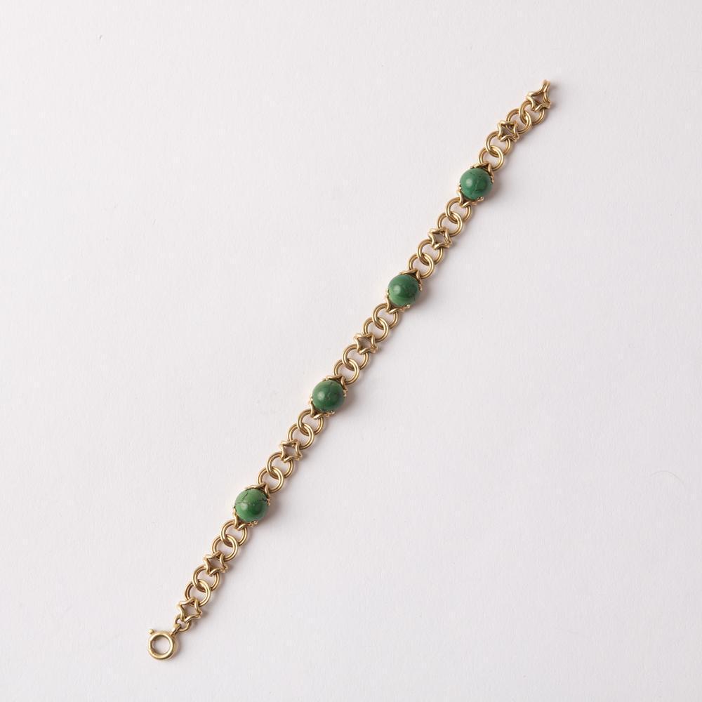 14K Green Turquoise Cabochon Link Bracelet: 14K yellow gold link bracelet with four prong set green / aged turquoise cabochons. The cabochons measure 8.5mm to 9mm round. The links measure 7mm wide. The bracelet has a spring ring clasp and 