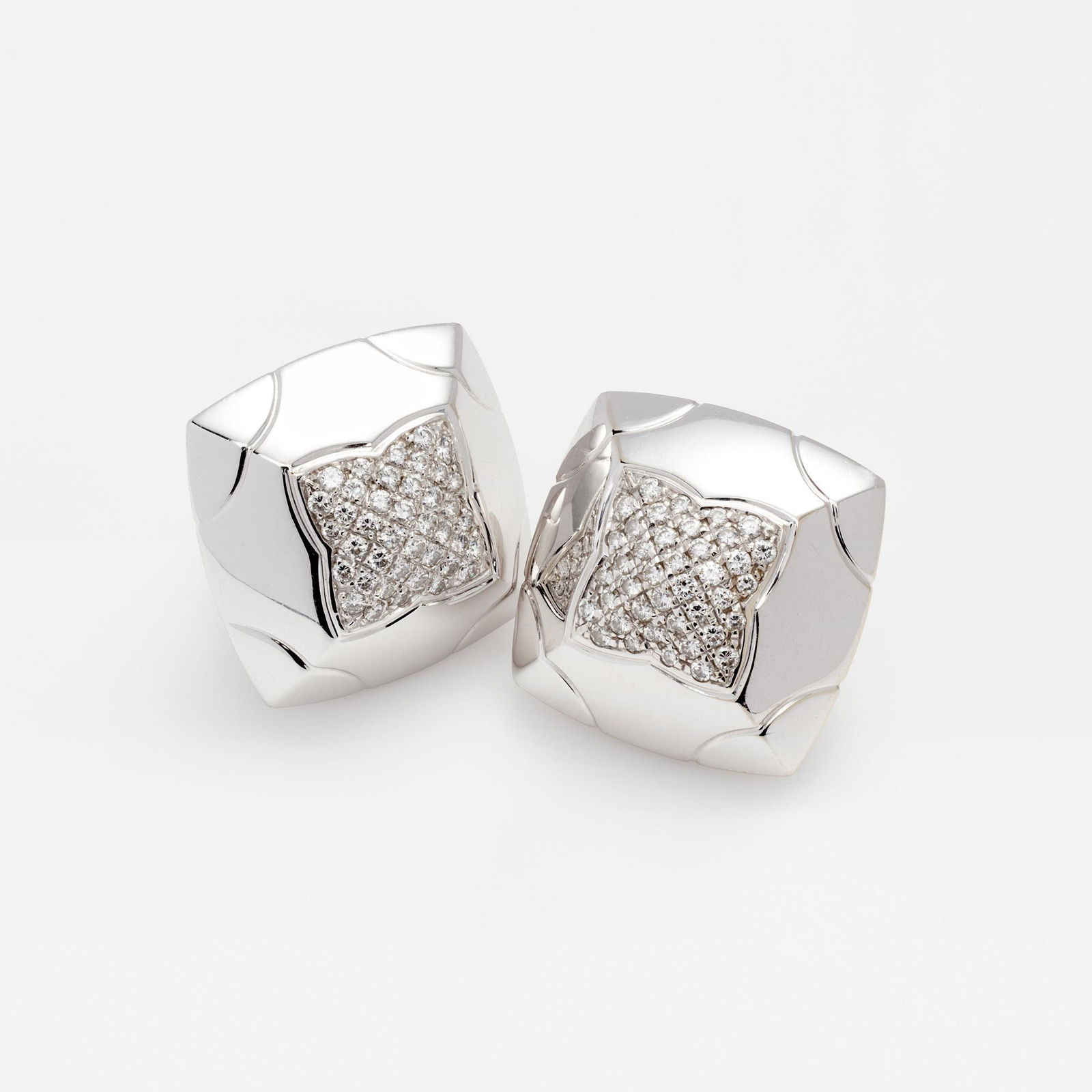 Bvlgari Pyramid Diamond Pave' 18k Earrings: A pair of diamond pyramid clip earrings by Bvlgari. These 18k white gold earrings are from the pyramid collection and have 40 diamonds on each earring with 1.66 carat total weight of diamonds on the p