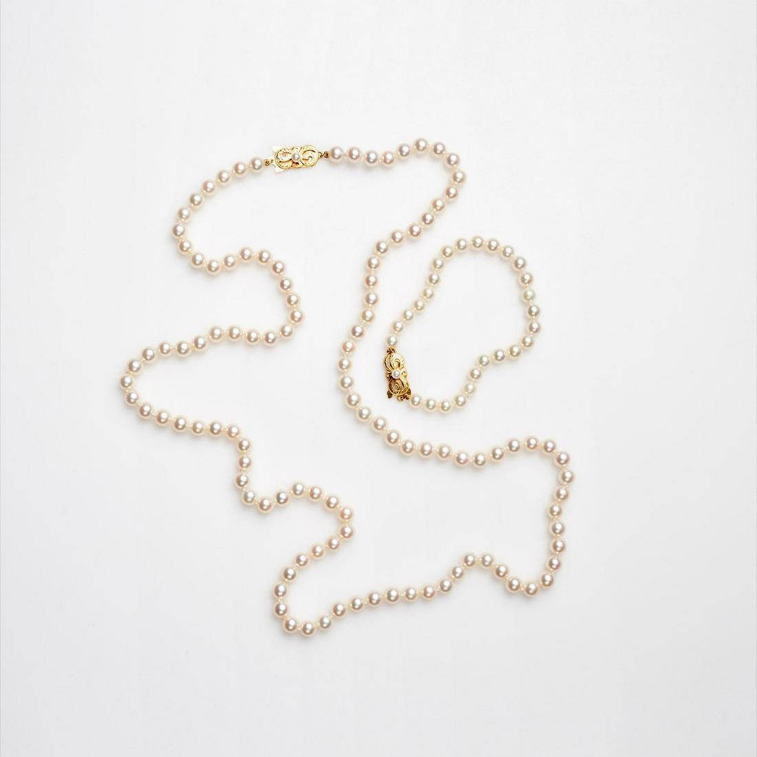 Mikimoto Akoya Cultured Pearl Necklace / Bracelet: A matching Mikimoto akoya cultured pearl opera necklace and bracelet, with the Mikimoto 18k yellow gold clasp featuring a single pearl and French wire. The individually knotted pearls are well matched