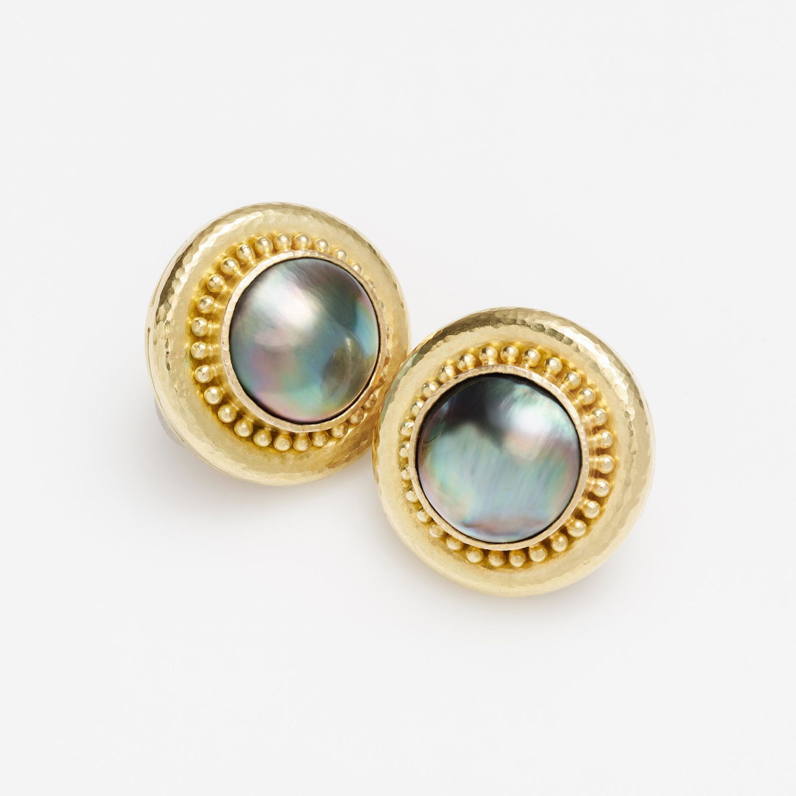 Elizabeth Locke 18k Abalone Earrings: A pair of Elizabeth Locke round earrings with a bezel set abalone shell surrounded with gold dots on an 18k yellow hammered gold frame. The earrings have French omega backs with a collapsible post mak
