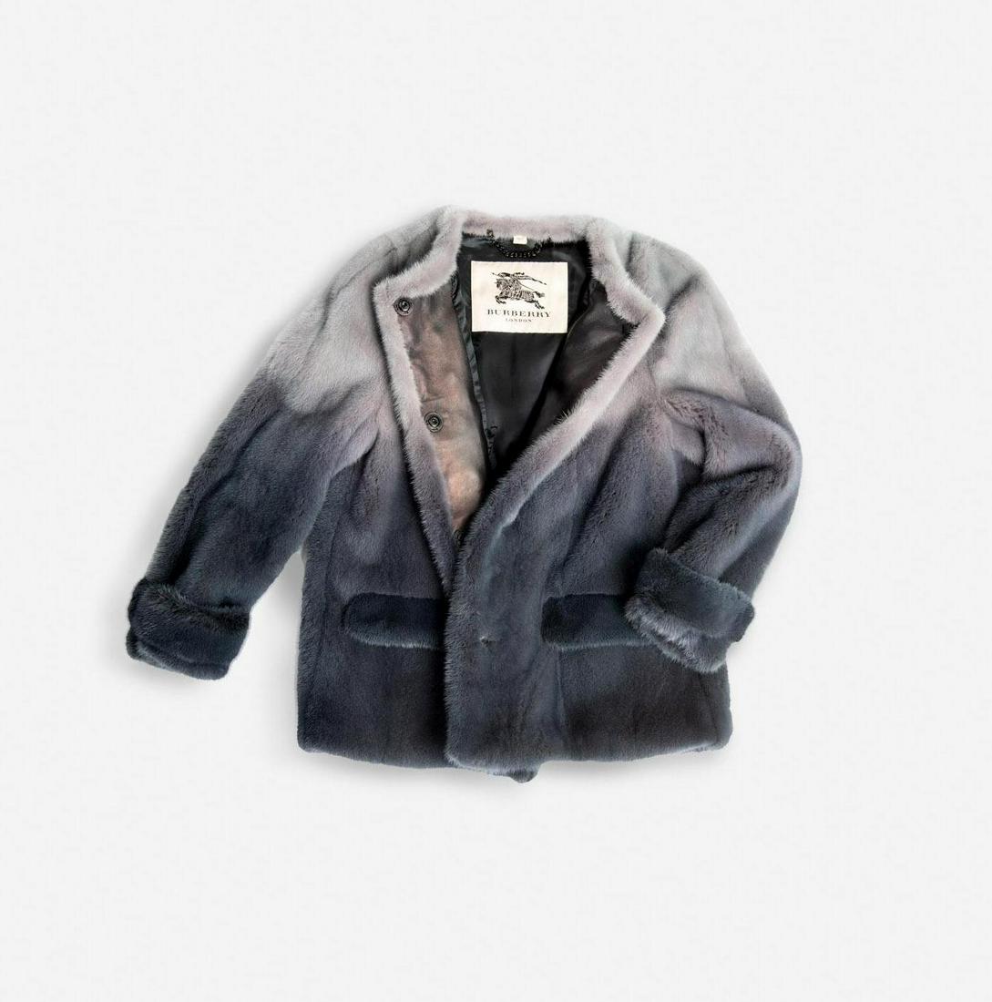 Burberry Mink Hand Dyed Fur Coat: A Burberry lavender ombre mink coat. This fur coat is hand dipped dyed mink fur with leather on the interior front closure section. There are four snap buttons down the front, two front flap pockets,