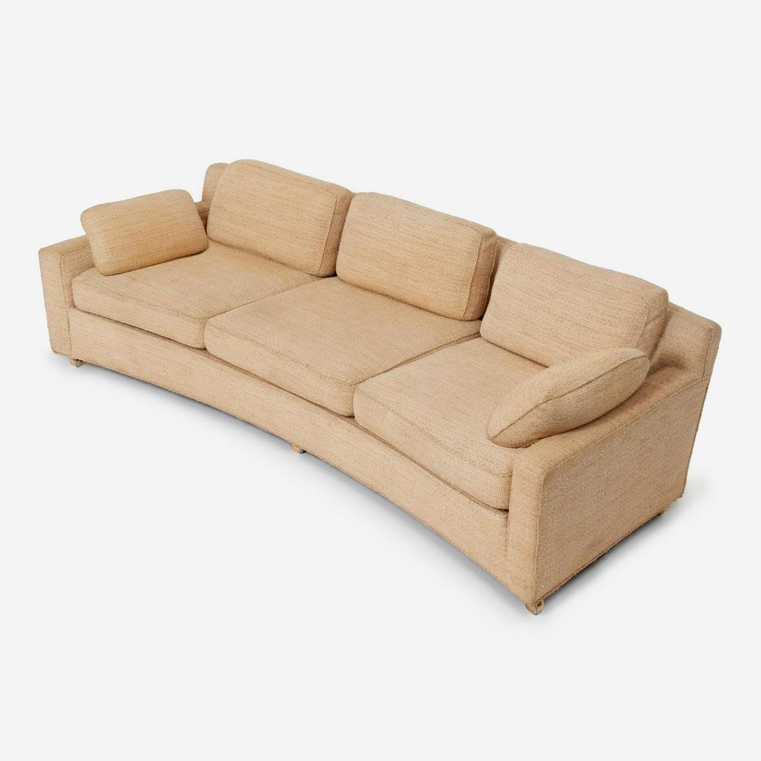 EDWARD WORMLEY Dunbar Curved Cream Sofa (1950s): Edward Wormley for Dunbar Conversational sofa Circa 1950s Walnut, upholstery 30" x 96" x 40" "Dunbar for Modern / Designed by Edward Wormley" fabric label under the seat. Set on casters. Covered i