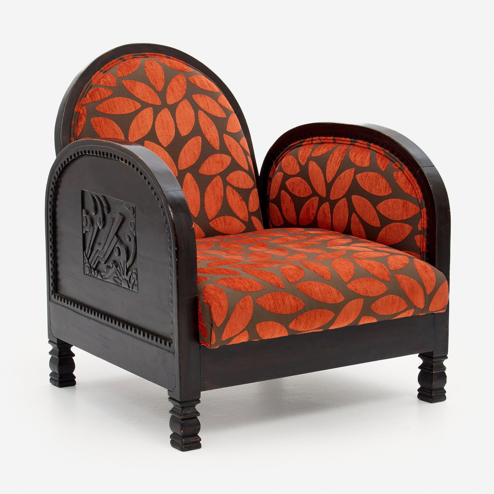 Shanghai Deco Club Chair: A vintage low club chair labeled Shanghai Deco, dark stained fruitwood with custom upholstery, the sides having relief medallions. The chair measures 29 1/2" x 25 1/2" x 32", with a sea