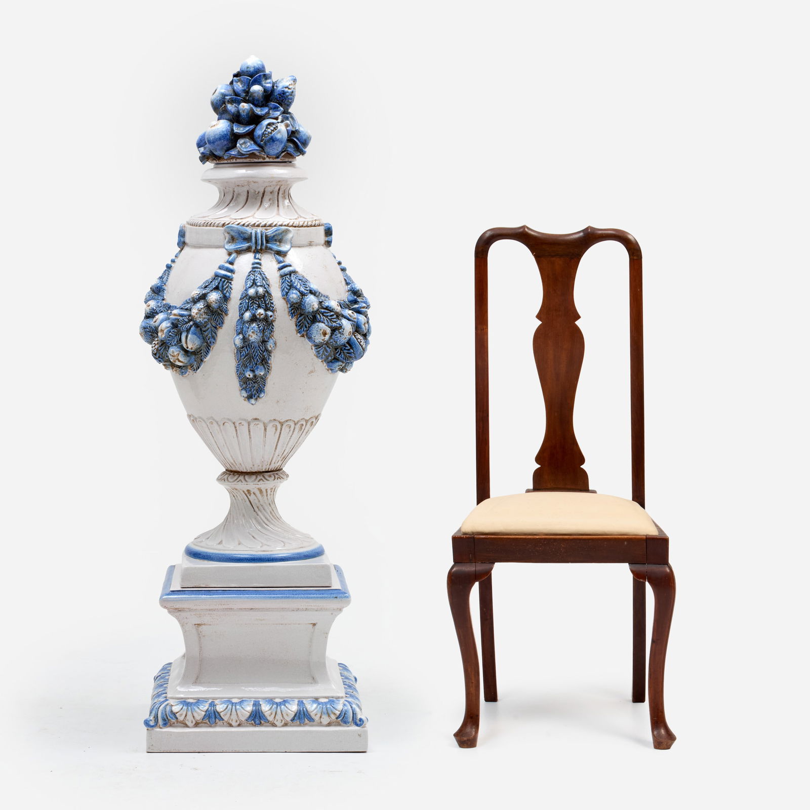 Large Italian Maiolica Garden Urn: A maiolica garden urn with cover on stand, terracotta with blue and white glazes, with molded festoon and fruit motifs. Italian, circa mid-20th century. Measures 57 1/2" x 19" x 19".