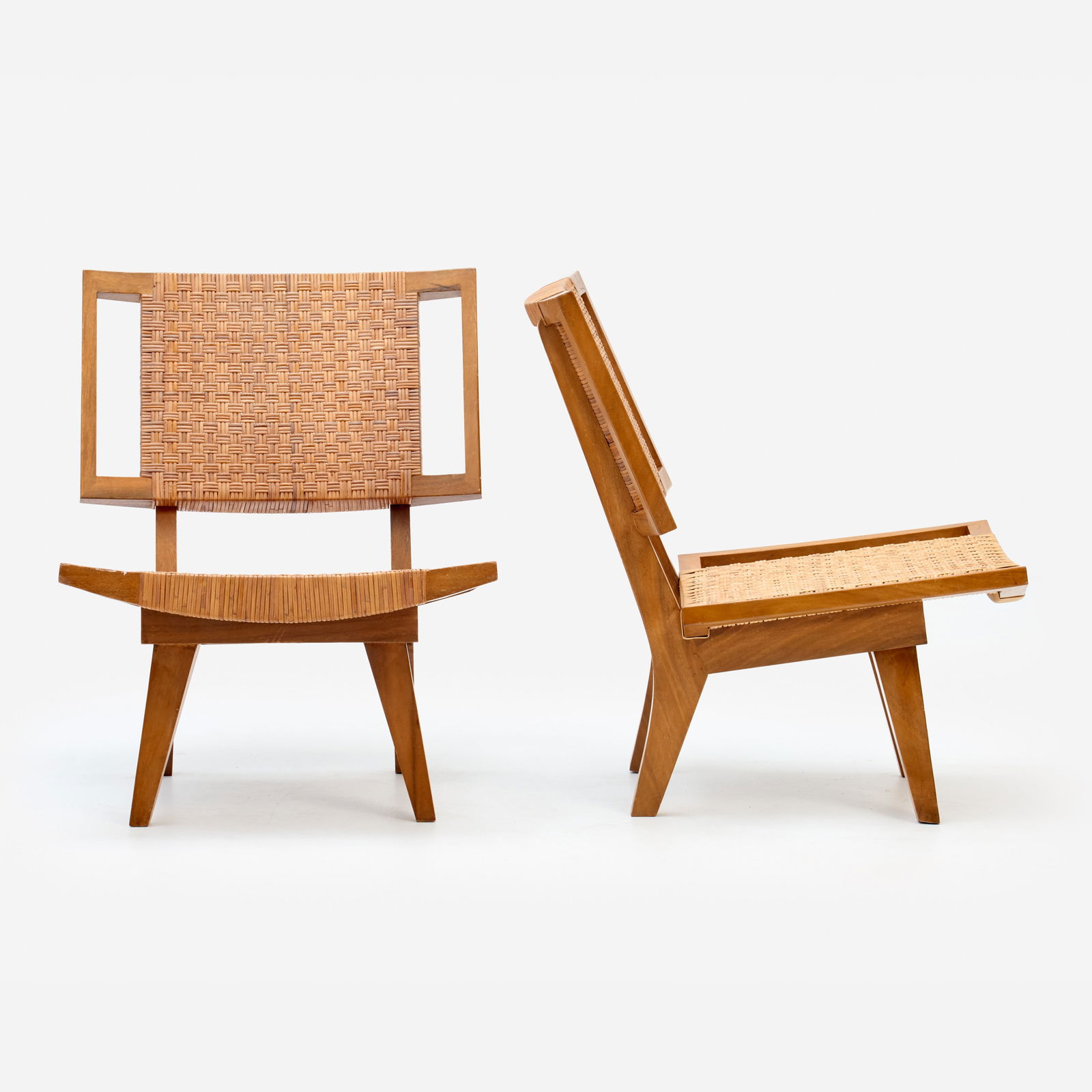 Paul Laszlo Style Pair of Lounge Chairs (ca. 1950s): Paul Laszlo (style of) Pair of lounge chairs Circa 1950s Bleached mahogany, cane 31" x 24 1/2" x 30 1/2" A striking pair of easy chairs, unmarked, bearing a strong resemblance to Laszlo's