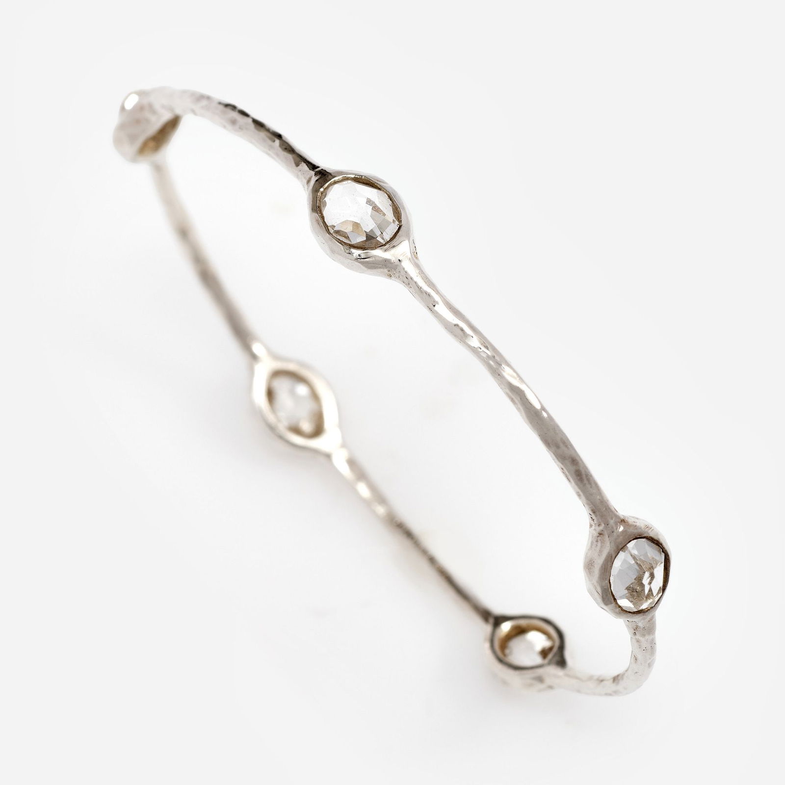 Ippolita 5-stone Quartz Bangle w/pouch #2: Ippolita small 5-stone bangle with clear faceted quartz stations with a hammered finish. Includes an Ippolita pouch. Metal: Sterling Silver Weight: 8.4 dwt Measurements: Stones: 7x9 mm oval Marki