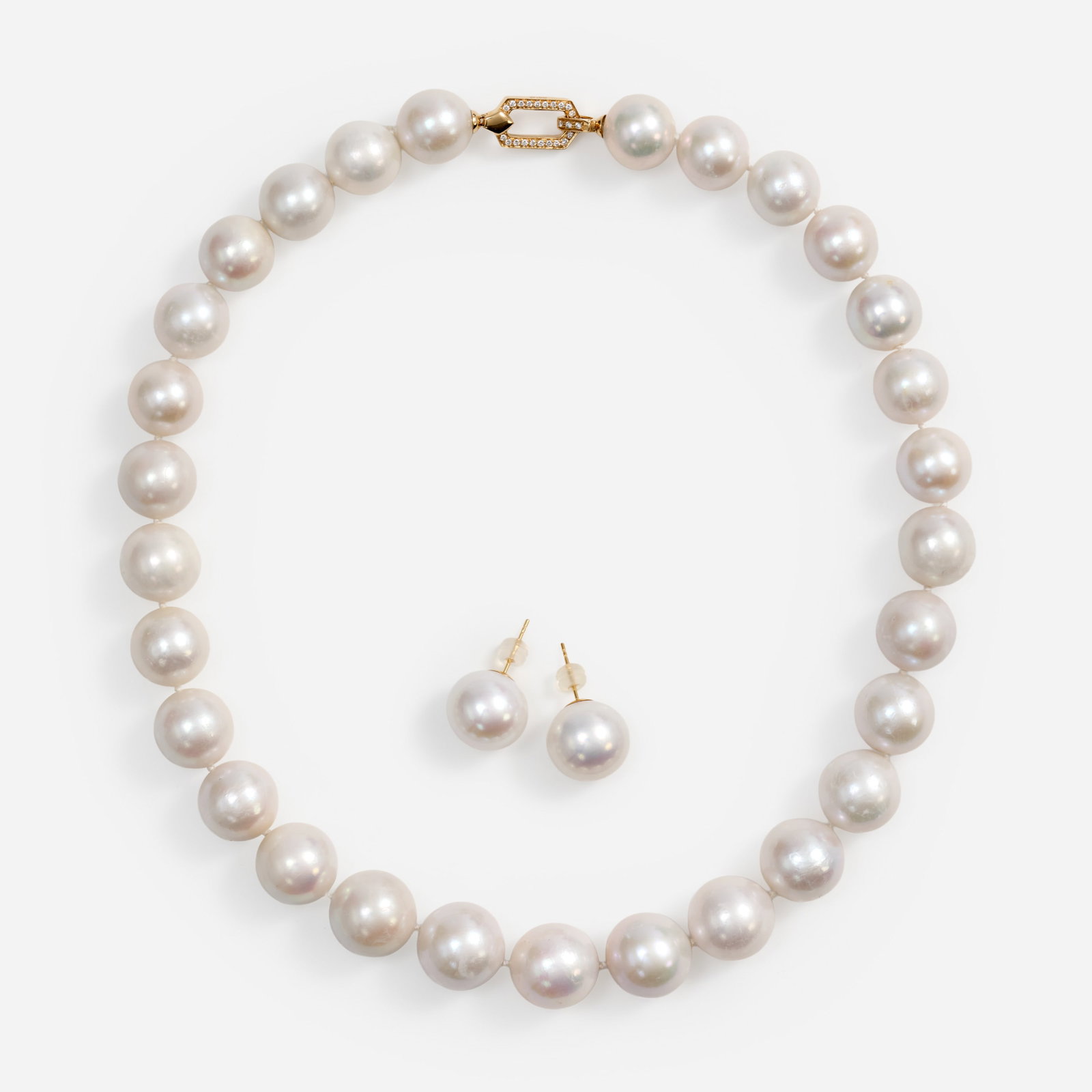 Designer South Sea Pearls Graduated Strand w/Earrings: A designer strand of graduated South Sea Pearls with 14K yellow gold clasp set with diamonds and a matching pair of South Sea Pearl earring studs with 18k posts. Diamond Attributes: The clasp is 
