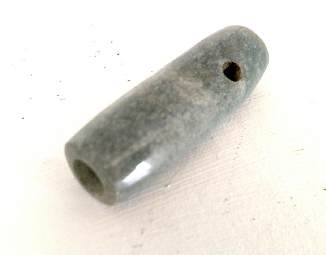 Costa Rican Fine Jade Tubular Bead: Costa Rican Fine Jade Tubular Bead. Nicoya/Guanacaste. BCE 300-CE 800. Blue green jadeite. Length: 2 in. Very fine condition with calcified soil and mineral deposits. Provenance: Private Washington st