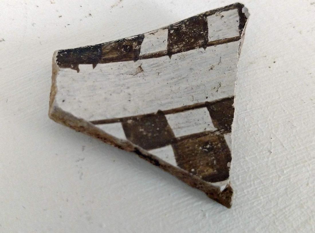 Anasazi Pot Shard CE 1000-1400: Anasazi Pot Shard CE 1000-1400. New Mexico/Arizona/Colorado. Gray earthenware with white slip and black paint. Width: 2 in. Fine condition with mineral deposits overall. Provenance: Oh private collect