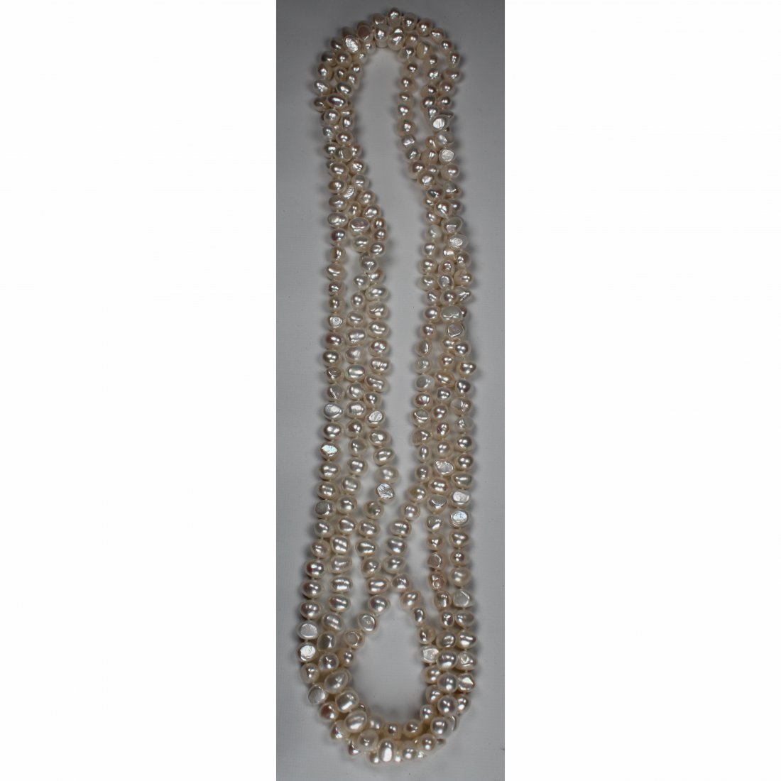 Unusual 100 inch Strand of White Freshwater Pearls: 100 inch Strand of White Freshwater Pearls. This strand of pearls ranges from 9-10 mm in size.