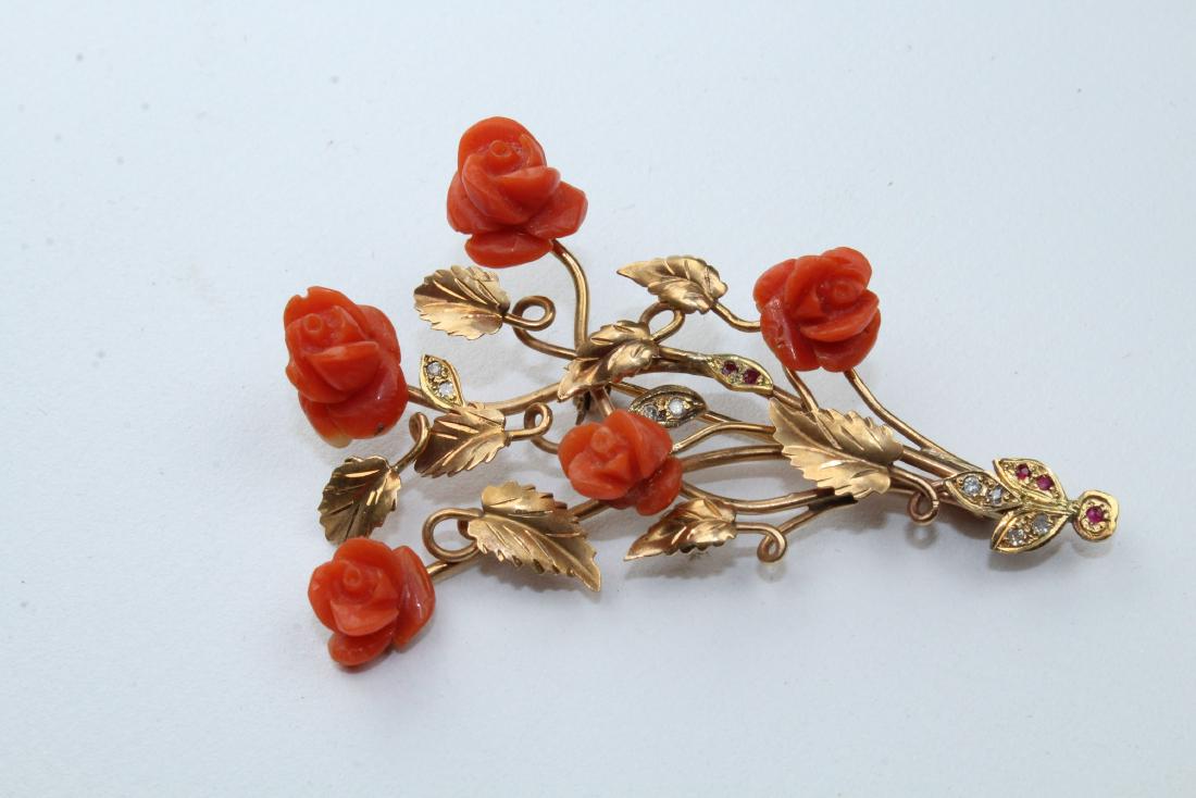 18k Gold, Red Coral, Diamond & Ruby Floral Pin: 18k Gold, Red Coral, Diamond & Ruby Floral Pin. Having 5 carved red coral flowers, 8 small diamonds, and 5 small rubies make up a beautifully done floral pin. Stamped (18k) on pin.