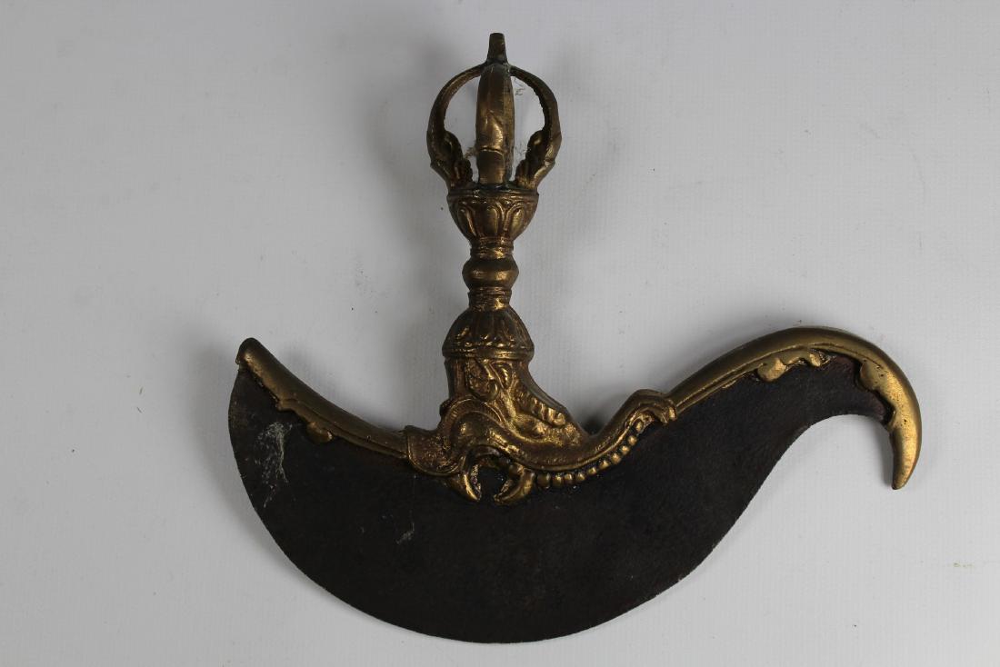 Gilt Bronze Tibetan Buddhism Kartika: A kartika is a small, crescent-shaped hand-held ritual flaying knife used in the tantric ceremonies of Vajrayana Buddhism. The kartika is said to be "one of the quintessential attributes of the wrathf