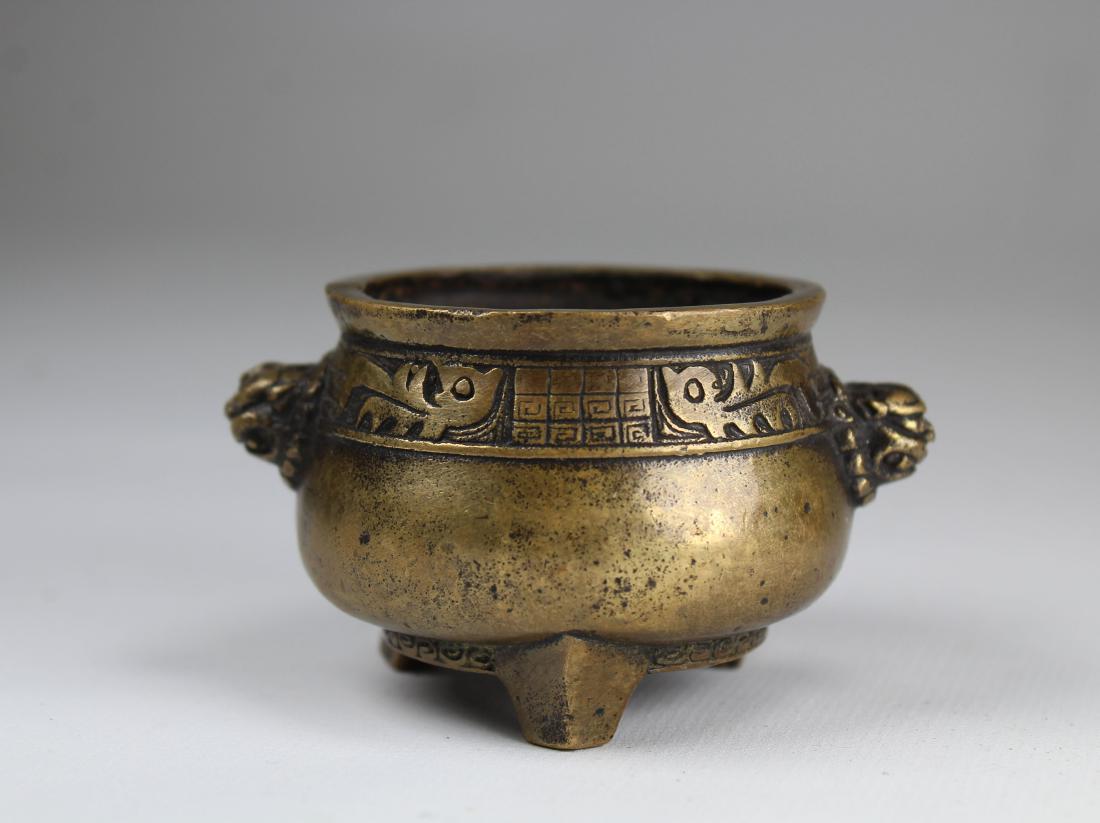 Signed, Bronze Chinese Footed Censer: Signed, Bronze Chinese Footed Censer with twin foo dog masks on either side. Diameter: 3 inches.