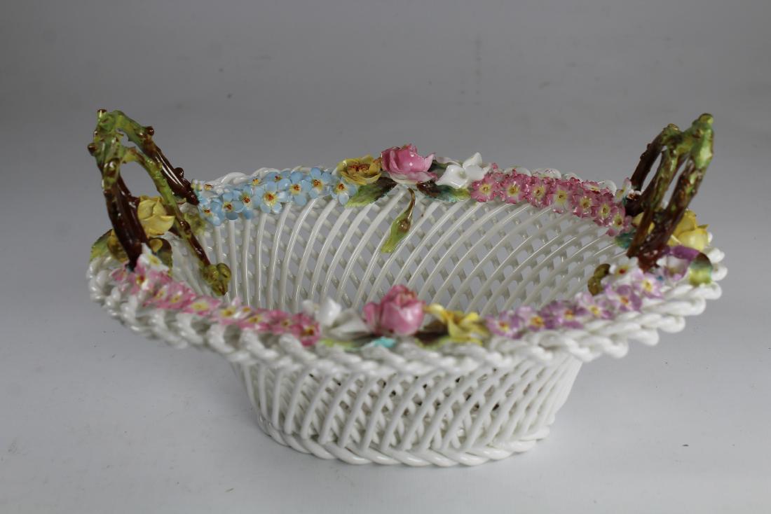 Staffordshire Lattice Ware Porcelain Basket: English Staffordshire Lattice Ware Porcelain Basket. Having beautifully done floral arrangement pattern around top rim and vine stylized handles on each end. Marked on base. Width: 9.5 in.