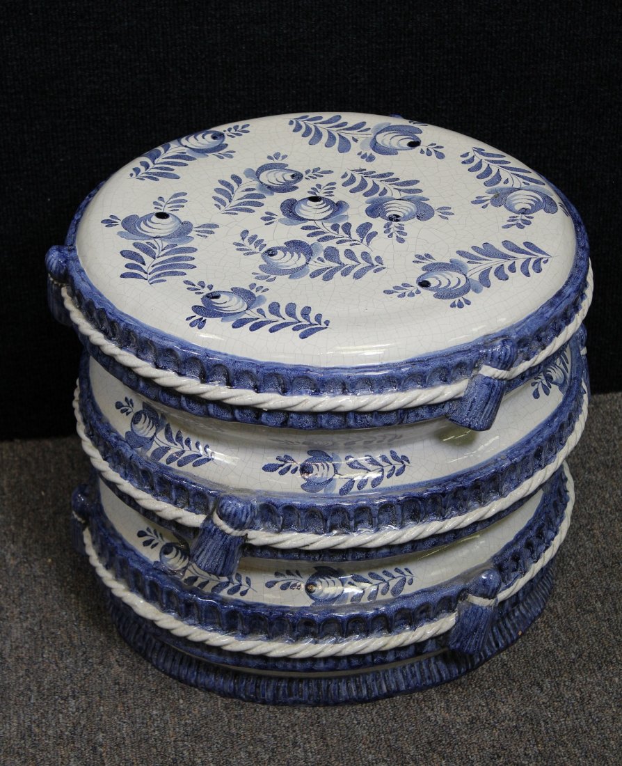 Italian Porcelain Garden Seat: Having white and blue crackle glaze with rope and tassel motif around outside. Marked 'Italy for Meiselman Imports' inside seat. Dimensions: 13 x 15.75 in.