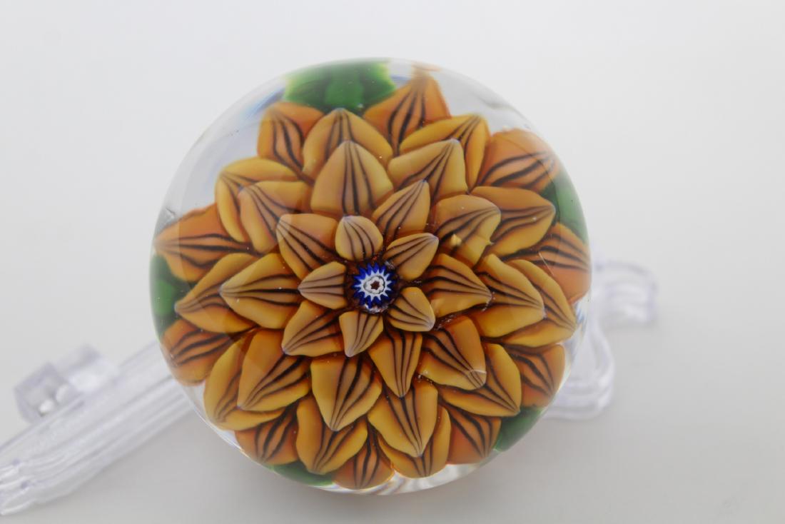 Antique Saint Louis Dahliah Paperweight: Antique Saint Louis Dahliah Paperweight. Flower composed of five rows of overlapping shaded deep-yellow petals with dark purple markings about a cobalt-blue, red and white central cane, the flower res
