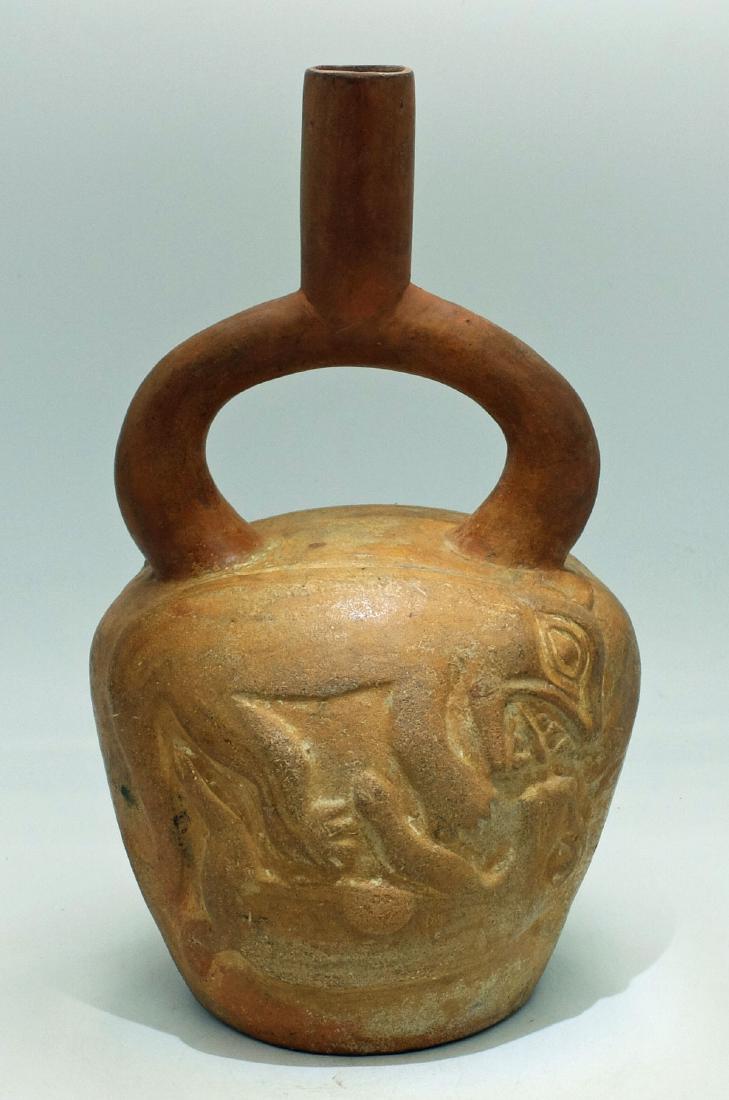 Moche IV Bottle - Peru, ca. 450 - 550 AD: An excellent Moche IV bottle from Peru, ca. 450 - 550 AD. This lovely orangeware vessel is 10" high and features two depictions of a jaguar attacking a deer. The scenes are molded in high relief and r