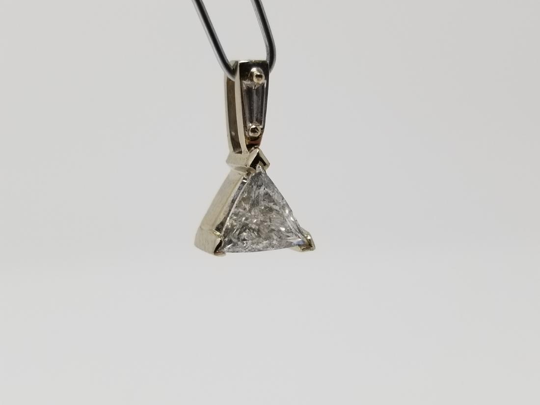Trilliant Solitaire Diamond 14K Pendant: Uniquely styled solitaire triangular pendant crafted with a natural Trilliant cut diamond with a tapered baquette cut diamond above main stone. Total Weight: 1.6 g. Approx. Diamond Weight: .8ct - All 
