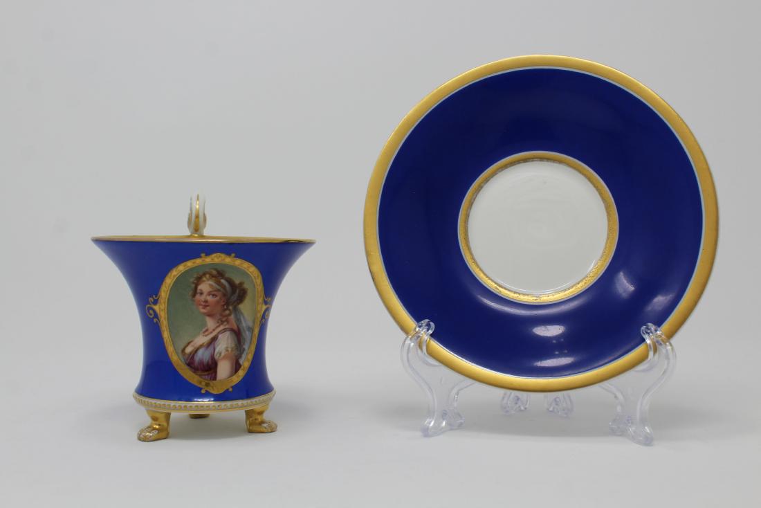 Antique KPM Porcelain Footed Cup & Saucer: Antique KPM Porcelain Footed Cup & Saucer with Hand Painted Portrait of a Woman on the front of cup. Marked on bottom. Diameter of dish: 5.75 inches.