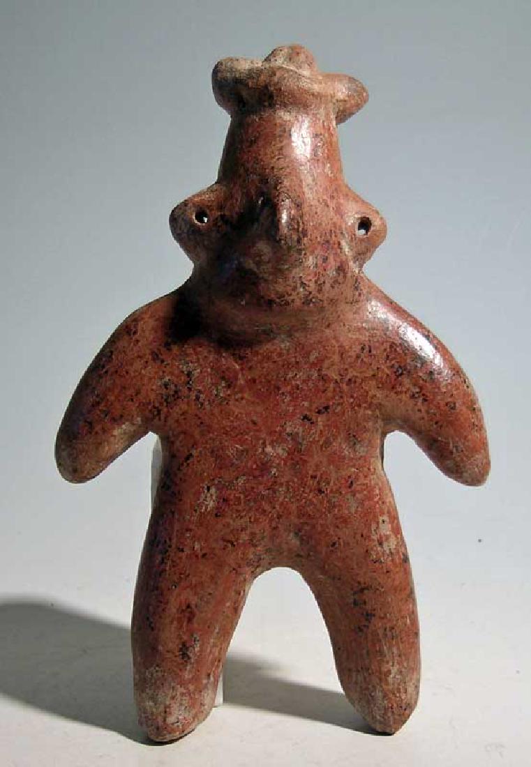 Colima figure - West Mexico, 300 BC - 300 AD: A fine Colima figure from West Mexico, ca. 300 BC - 300 AD. This standing male is 7.5" high and is adorned with a headdress wrapped around his elongated head and perforated ears that indicate ear spoo